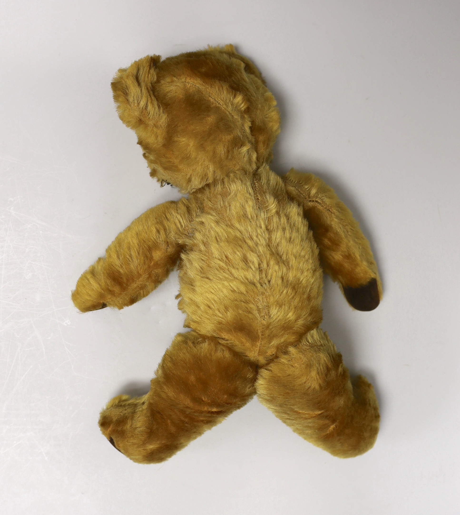 A mid 20th century teddy bear, probably Merrythought, 37cm high